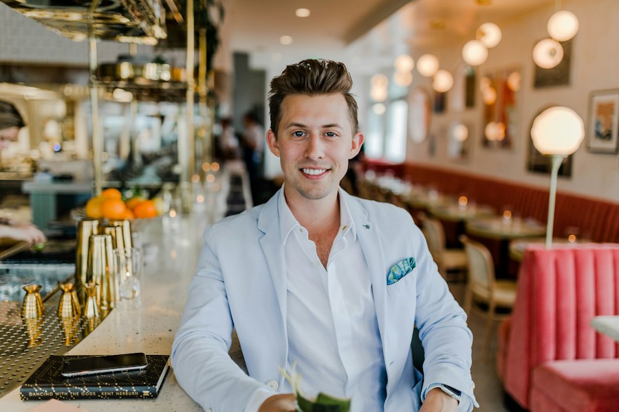 A restaurant owner smiling in his dining room